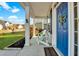 Inviting covered front porch with white rocking chairs and blue door at 402 Spectrum Rd, Summerville, SC 29486