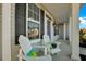 Inviting front porch with white rocking chairs and black shutters at 402 Spectrum Rd, Summerville, SC 29486
