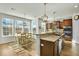 Sunlit kitchen with stainless appliances, wood cabinets and adjacent dining area at 402 Spectrum Rd, Summerville, SC 29486