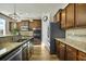 Kitchen with stainless steel appliances, granite countertops, and dark wooden cabinets at 402 Spectrum Rd, Summerville, SC 29486