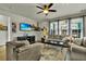 Well-lit living room offers comfortable sofas, hardwood floors, and a modern ceiling fan at 402 Spectrum Rd, Summerville, SC 29486