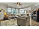 Bright living room features plush seating, a ceiling fan, and a seamless transition to the kitchen at 402 Spectrum Rd, Summerville, SC 29486