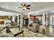 Open-concept home with hardwood floors connecting the living room, kitchen, and dining area at 402 Spectrum Rd, Summerville, SC 29486