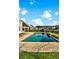 Backyard pool with a brick patio and lush landscaping has a peaceful view at 402 Spectrum Rd, Summerville, SC 29486
