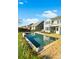 Backyard pool and patio with lounge chairs and a view of the house, which has a screened-in porch at 402 Spectrum Rd, Summerville, SC 29486