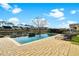 Sparkling pool with lounge chairs on a brick patio overlooking the neighborhood lake at 402 Spectrum Rd, Summerville, SC 29486