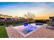 Backyard oasis with a sparkling pool reflecting the sunset, surrounded by brick pavers and lush landscaping at 402 Spectrum Rd, Summerville, SC 29486