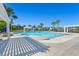 Large community pool with zero entry, pergola, palm trees and lounge chairs at 402 Spectrum Rd, Summerville, SC 29486