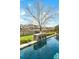 Intimate view of the pool's waterfall feature, showcasing serene backyard ambiance and meticulous landscaping at 402 Spectrum Rd, Summerville, SC 29486