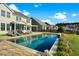 Backyard pool with lounge chairs and patio, with a clear view of the well-maintained lawn and neighboring homes at 402 Spectrum Rd, Summerville, SC 29486