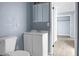 Well-lit bathroom featuring a white vanity and mirror, and a glimpse into an adjacent room at 407 Hayne St, Walterboro, SC 29488