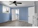 Bedroom with wood-look floors, ceiling fan, and ensuite bathroom at 407 Hayne St, Walterboro, SC 29488