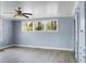 Bedroom with a ceiling fan, neutral walls and trim, and an exterior view from windows at 407 Hayne St, Walterboro, SC 29488