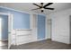Bedroom with a ceiling fan, built-in shelves, cabinets and wood look flooring at 407 Hayne St, Walterboro, SC 29488