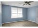 Light and airy bedroom with ceiling fan, window with blinds, and wood-look flooring at 407 Hayne St, Walterboro, SC 29488