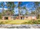 Traditional brick home featuring a covered carport, complemented by a well-maintained front lawn at 407 Hayne St, Walterboro, SC 29488