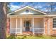 Inviting front porch with classic white columns, brick foundation, and front door at 407 Hayne St, Walterboro, SC 29488