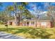 Charming brick home with a covered porch, mature trees, and a well-maintained front yard at 407 Hayne St, Walterboro, SC 29488