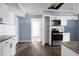 Bright kitchen featuring white cabinets, granite countertops, and stainless steel appliances at 407 Hayne St, Walterboro, SC 29488