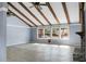 Open living room with vaulted ceiling, exposed wooden beams, and a brick fireplace at 407 Hayne St, Walterboro, SC 29488