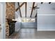 Open living room with a brick fireplace, vaulted ceilings, wood beams and lots of natural light at 407 Hayne St, Walterboro, SC 29488