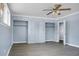 Bright main bedroom featuring a ceiling fan, closet space, and neutral paint at 407 Hayne St, Walterboro, SC 29488