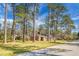 Brick home situated on a tree-lined street, featuring a well-manicured lawn and classic architecture at 407 Hayne St, Walterboro, SC 29488