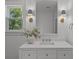 Bright bathroom with a decorative mirror, modern sconces, neutral vanity, and a large window with a view at 499 Lackland Ct, Mount Pleasant, SC 29464