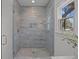 Sleek glass shower with gray tile, modern fixtures, and a window offering natural light and a view at 499 Lackland Ct, Mount Pleasant, SC 29464