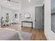 Airy bedroom featuring wood floors, a stylish console table, a round mirror, and an adjacent seating area at 499 Lackland Ct, Mount Pleasant, SC 29464