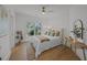 Airy bedroom with a cozy bed, ceiling fan, and a view overlooking the front yard at 499 Lackland Ct, Mount Pleasant, SC 29464
