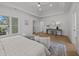 Spacious bedroom featuring a tray ceiling, a sitting area, wood floors, and ample natural light, creating an open feel at 499 Lackland Ct, Mount Pleasant, SC 29464