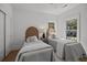 Charming bedroom with two twin beds, soft bedding, woven headboards, and natural light from bright windows at 499 Lackland Ct, Mount Pleasant, SC 29464