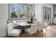 Cozy breakfast nook with a built-in bench, modern table, and large window with backyard view at 499 Lackland Ct, Mount Pleasant, SC 29464