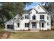 Stunning two-story brick home with white exterior, well-manicured lawn, and charming architectural details at 499 Lackland Ct, Mount Pleasant, SC 29464