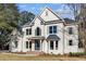Attractive white two-story home featuring a gray roof, well-kept lawn, and classic window designs at 499 Lackland Ct, Mount Pleasant, SC 29464