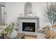 Close-up of the fireplace with a marble surround, decorative mirror, and comfortable seating at 499 Lackland Ct, Mount Pleasant, SC 29464