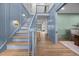Elegant foyer with light blue wall, staircase, and hardwood floors, creating a bright and open entrance at 499 Lackland Ct, Mount Pleasant, SC 29464