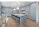 Spacious kitchen with large island, modern blue cabinets, marble countertops, and pendant lighting at 499 Lackland Ct, Mount Pleasant, SC 29464