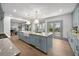 Spacious kitchen island with a farmhouse sink, marble countertops, and stylish pendant lighting at 499 Lackland Ct, Mount Pleasant, SC 29464