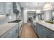 A modern kitchen featuring gray cabinets, marble countertops, a farmhouse sink, and professional grade appliances at 499 Lackland Ct, Mount Pleasant, SC 29464