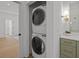 Laundry closet featuring a stackable washer and dryer, adjacent to the bathroom vanity at 499 Lackland Ct, Mount Pleasant, SC 29464
