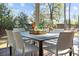Screened porch dining area offering a view of the peaceful, private backyard and greenery beyond at 499 Lackland Ct, Mount Pleasant, SC 29464