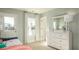 Bright bedroom features a bed, dresser with mirror, and access to the outdoors at 546 Richfield Way, Summerville, SC 29486