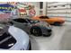 Well lit garage showcasing a collection of luxury sports cars and automotive-themed decor at 567 Faison Rd # 8, Mount Pleasant, SC 29466