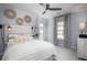 Cozy bedroom featuring stylish decor, ceiling fan, and a comfortable bed with decorative pillows at 593 Red Monarch Way, Moncks Corner, SC 29461
