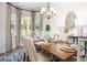 Elegant dining room with stylish chandelier, wainscoting, and a table set for a meal at 593 Red Monarch Way, Moncks Corner, SC 29461