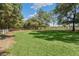 Vast backyard with lush greenery, mature trees, and a charming white fence at 5991 Joseph Blake Ln, Wadmalaw Island, SC 29487