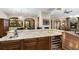 Wet bar with granite counters, custom cabinets and a wine fridge at 5991 Joseph Blake Ln, Wadmalaw Island, SC 29487