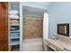This bathroom features a bathtub with shower and cabinet storage at 5991 Joseph Blake Ln, Wadmalaw Island, SC 29487